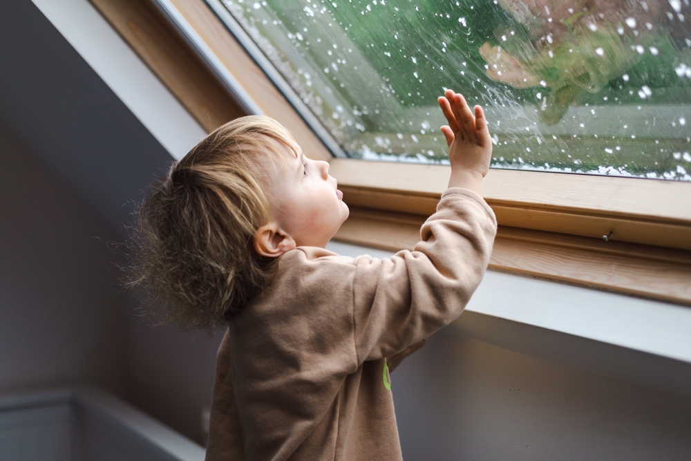 Little,Preschool,Boy,Staying,Home,In,Bad,Weather,And,Looking